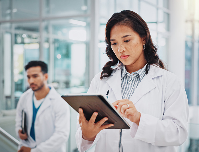 Tablet, laptop and woman scientist in lab working on medical research