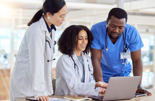 Tablet, collaboration and doctors talking planning in a modern hospital