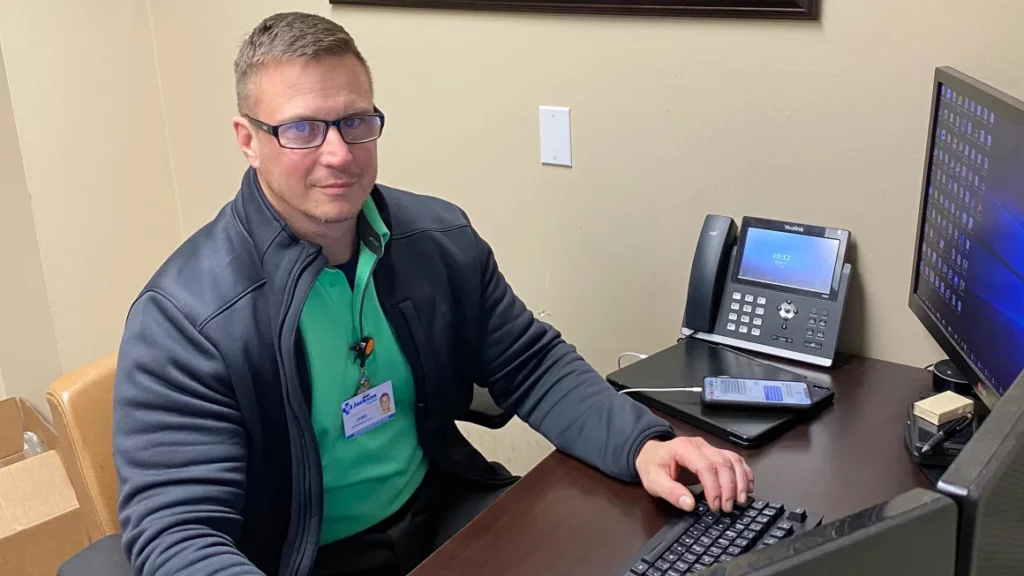 IT Director Jamie Hussey working at his desk as he helped stop a cyber attack.