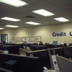 Empty credit union branch with dark computer screens
