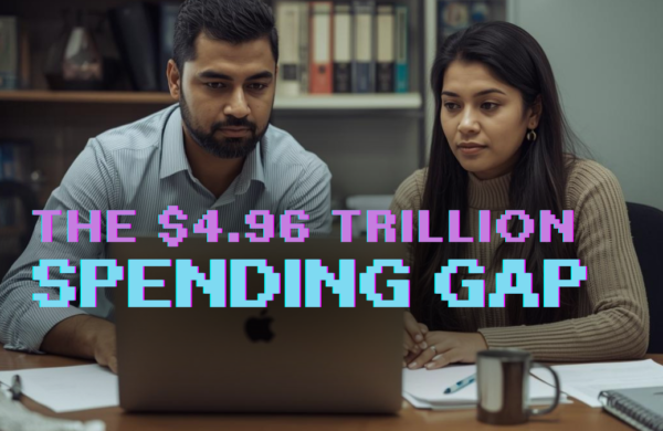 Business owner at a desk reviewing technology options on a laptop in a small office environment